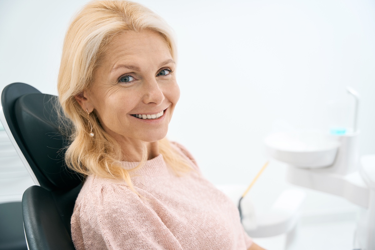 Lady sitting in dental chair waiting to have houston dental crown installed